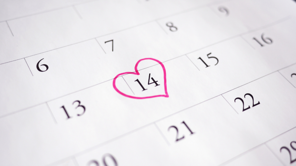 Image of a calendar with the 14th day of the month outlined with a pink heart.