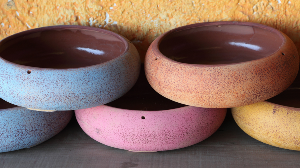 Several handmade pottery pieces in several colors