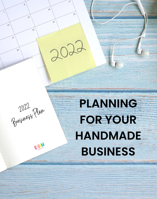 Blue wood surface with a calendar and notes that say 2022 Planning For your Handmade Business