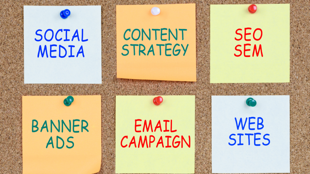 Set of six post it notes on a bulletin board that say social media, content strategy, seo sem, banner ads, email campaign and web sites.