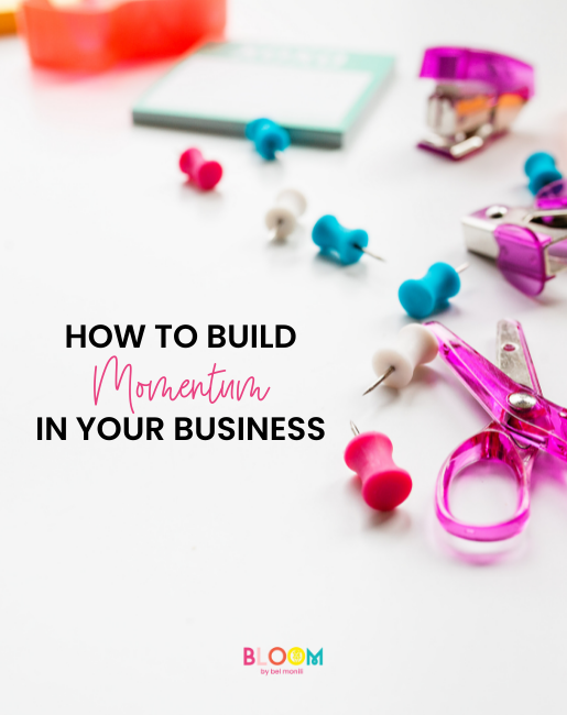 colorful pushpins and scissors on a desk with the title how to build momentum in your business