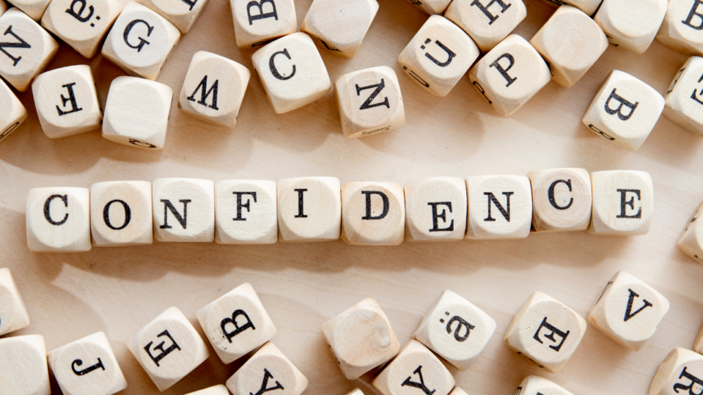 the word confidence spelled out with wooden cubes