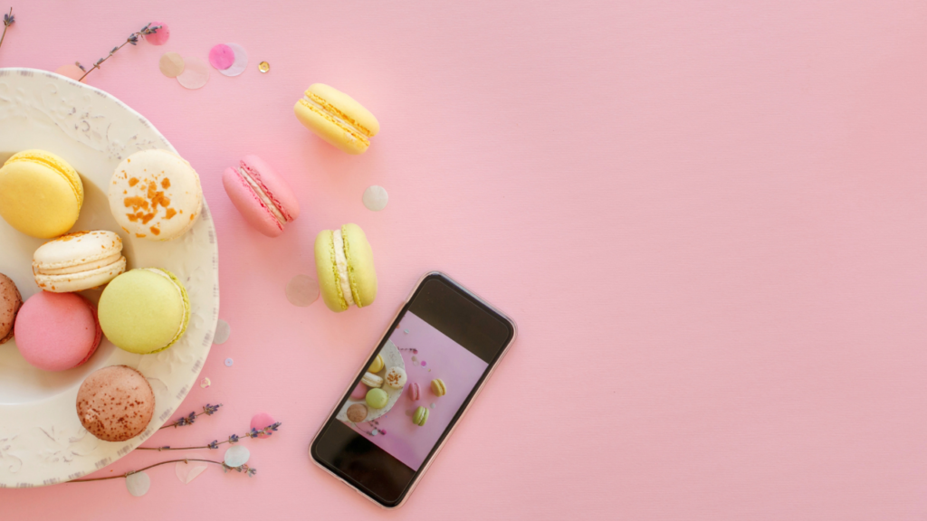 a plate of macaroons and a phone with an image of the plate on it