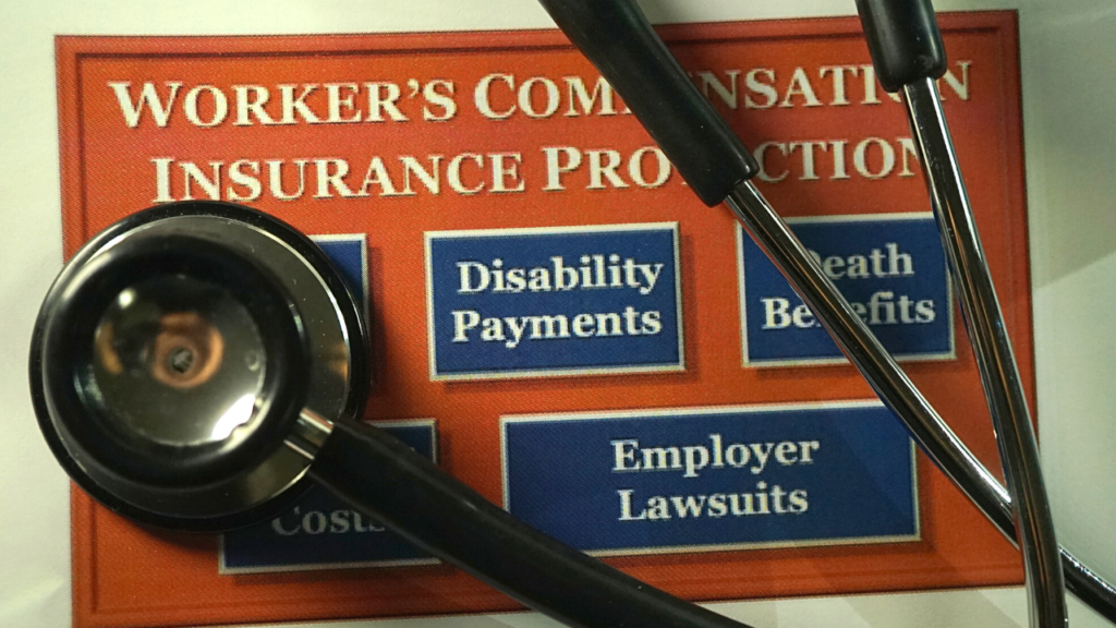 workers compensation insurance sign with a stethoscope on top of it