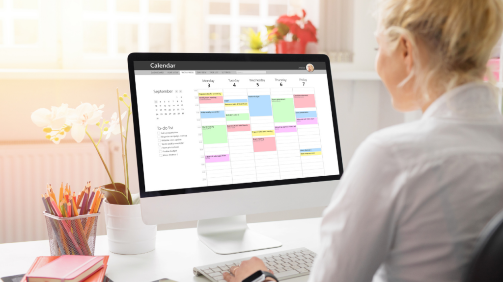 time blocking can help with maximizing productivity. Woman looking at time block schedule on her computer.