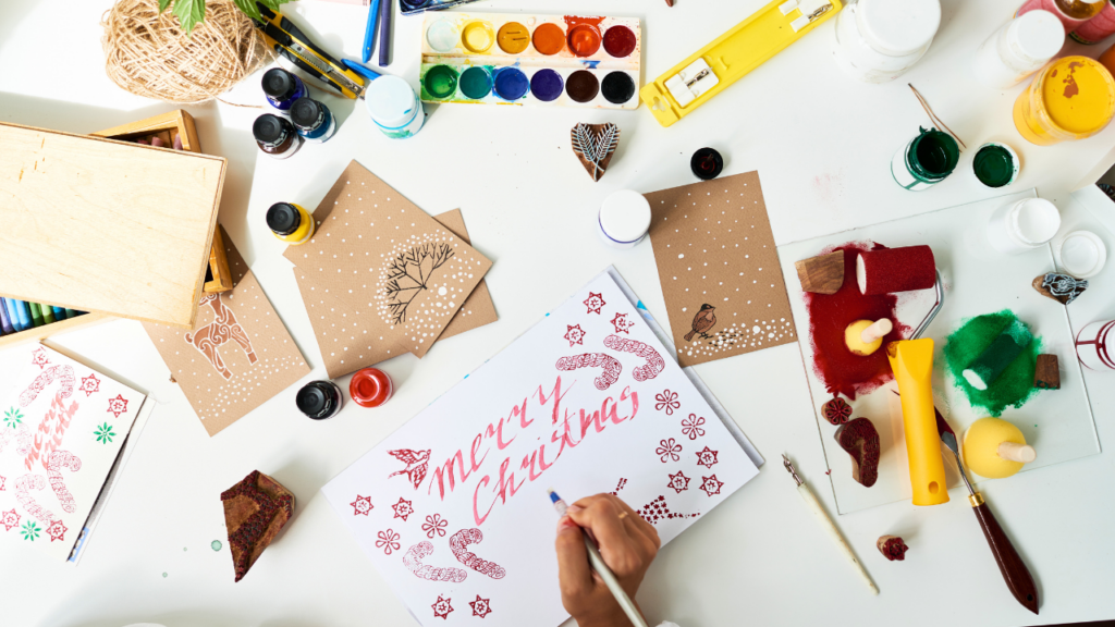 Handmade christmas stationery with paints around it
